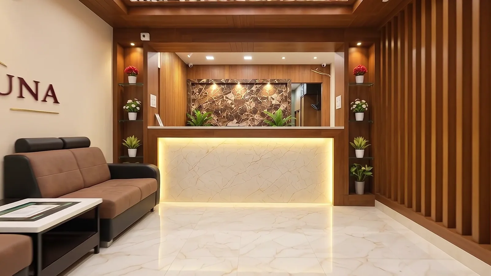 Close view of the illuminated marble front desk with a stone feature wall